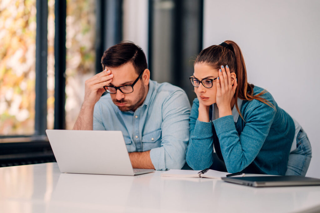 Worried business couple receiving bad news